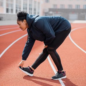A person in a dynamic but graceful lunge position.